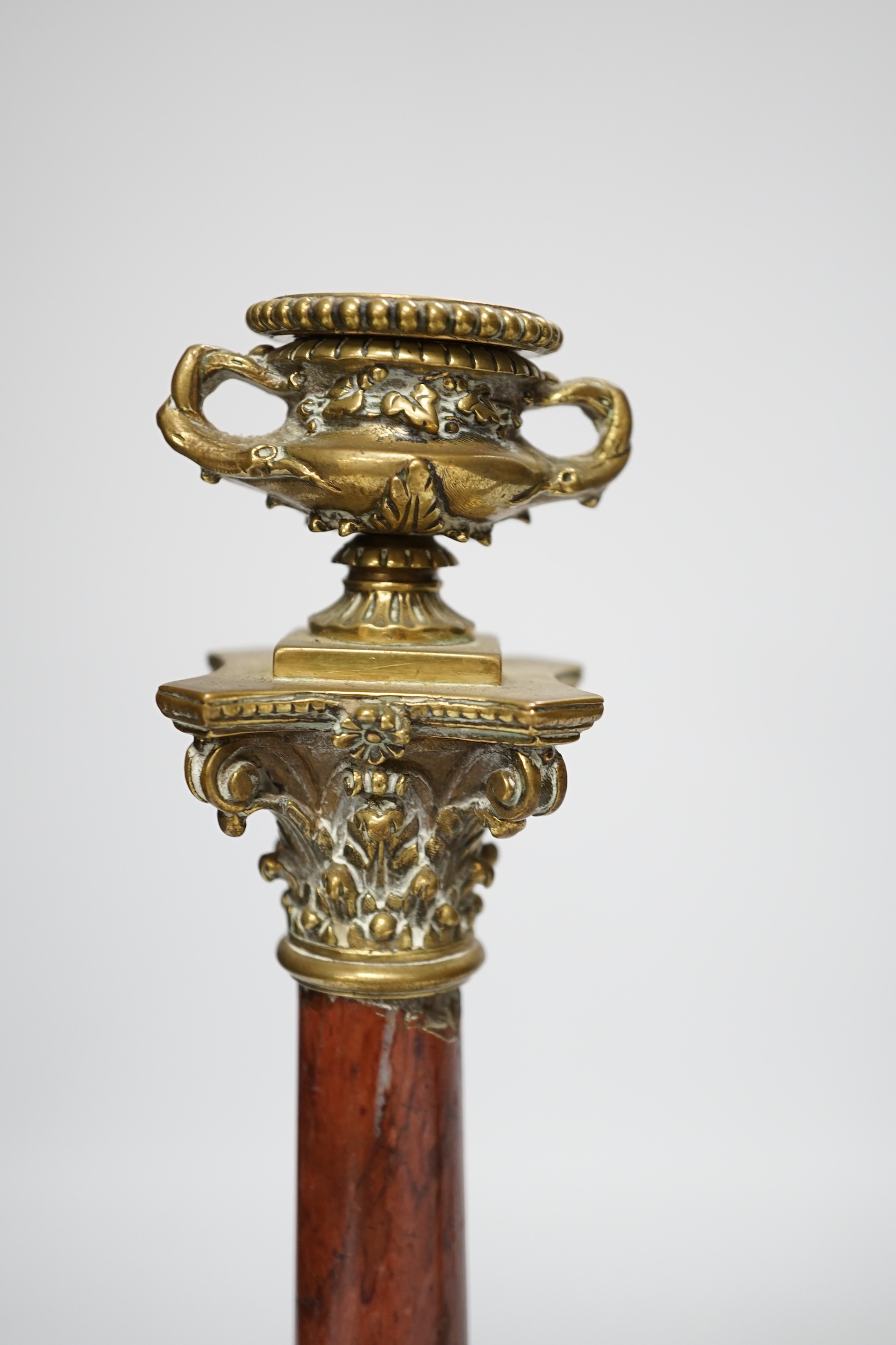 A pair of 19th century brass mounted rouge marble candlesticks, 29cm (a.f.)